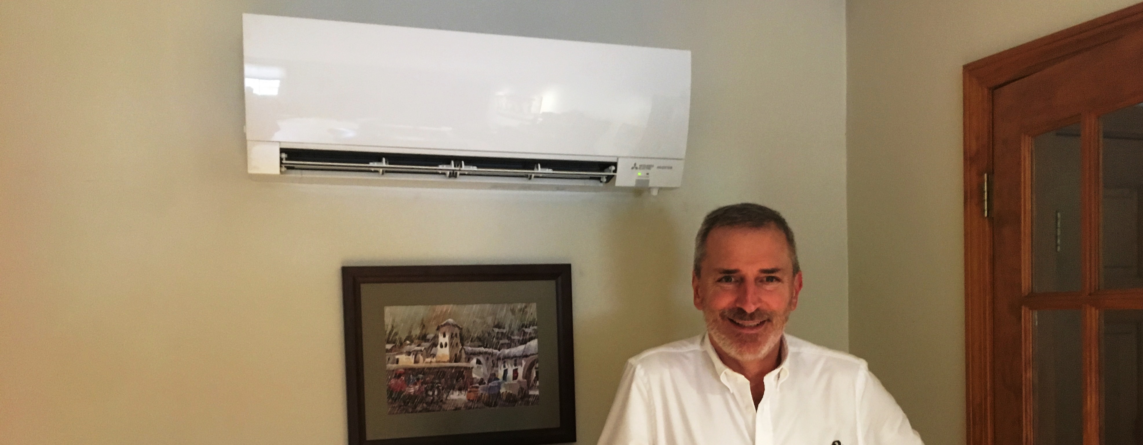 member standing in front of a heat pump