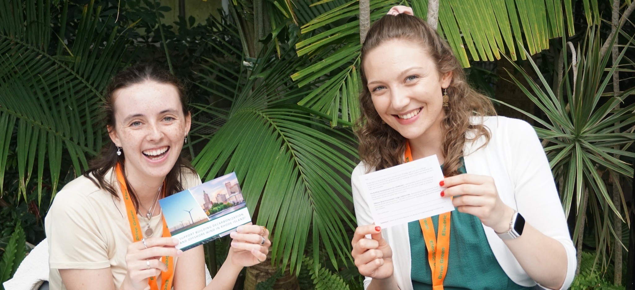 Amanda and Tina holding decarbonization postcards at spring meeting 2026