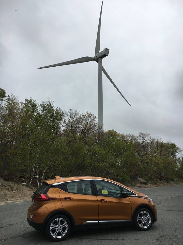 Chevy Bolt in front of one our Green Powered Wind Turbines in Gloucester, MA