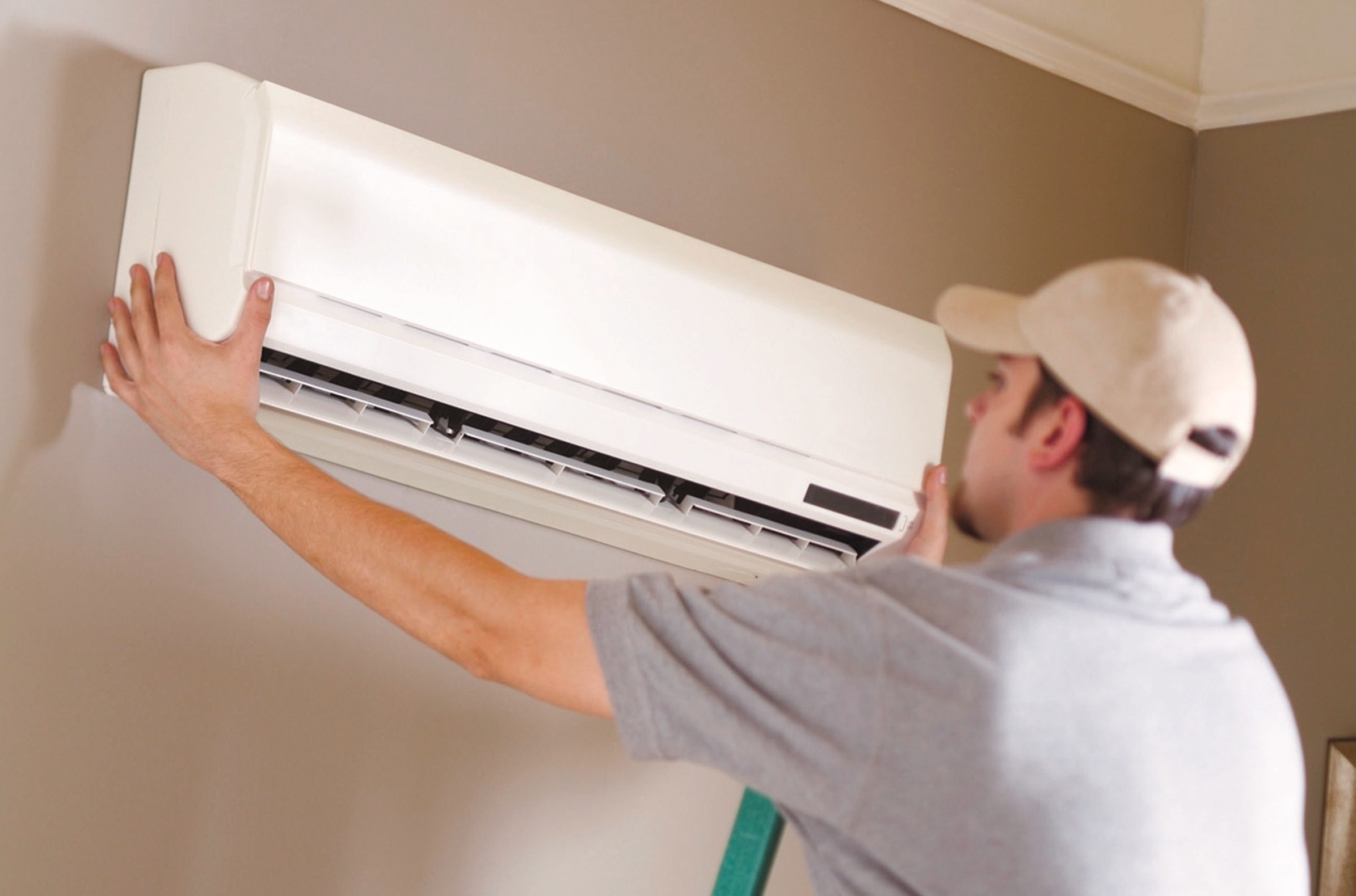 man installing heat pumps