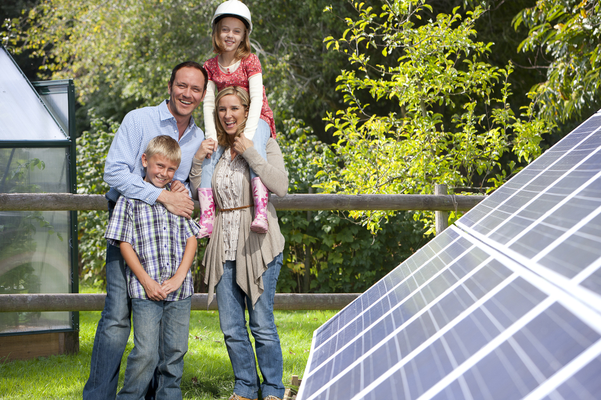 family in front of solar panels
