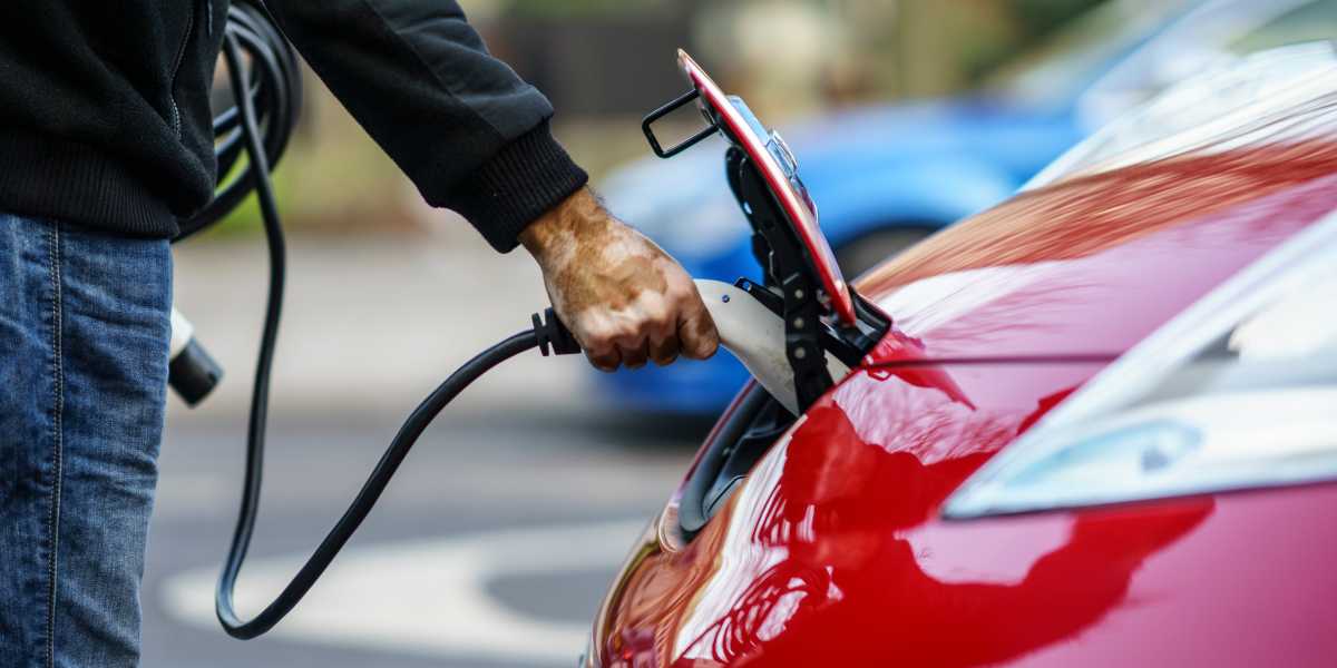 Man charging electric car