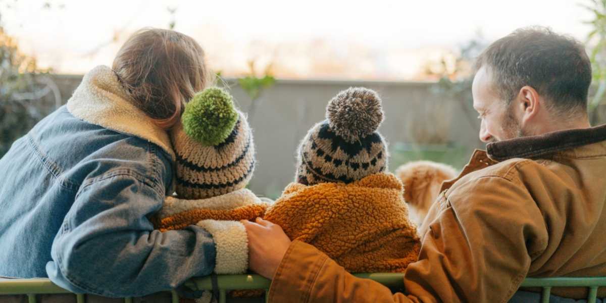 family bundled up during heating season