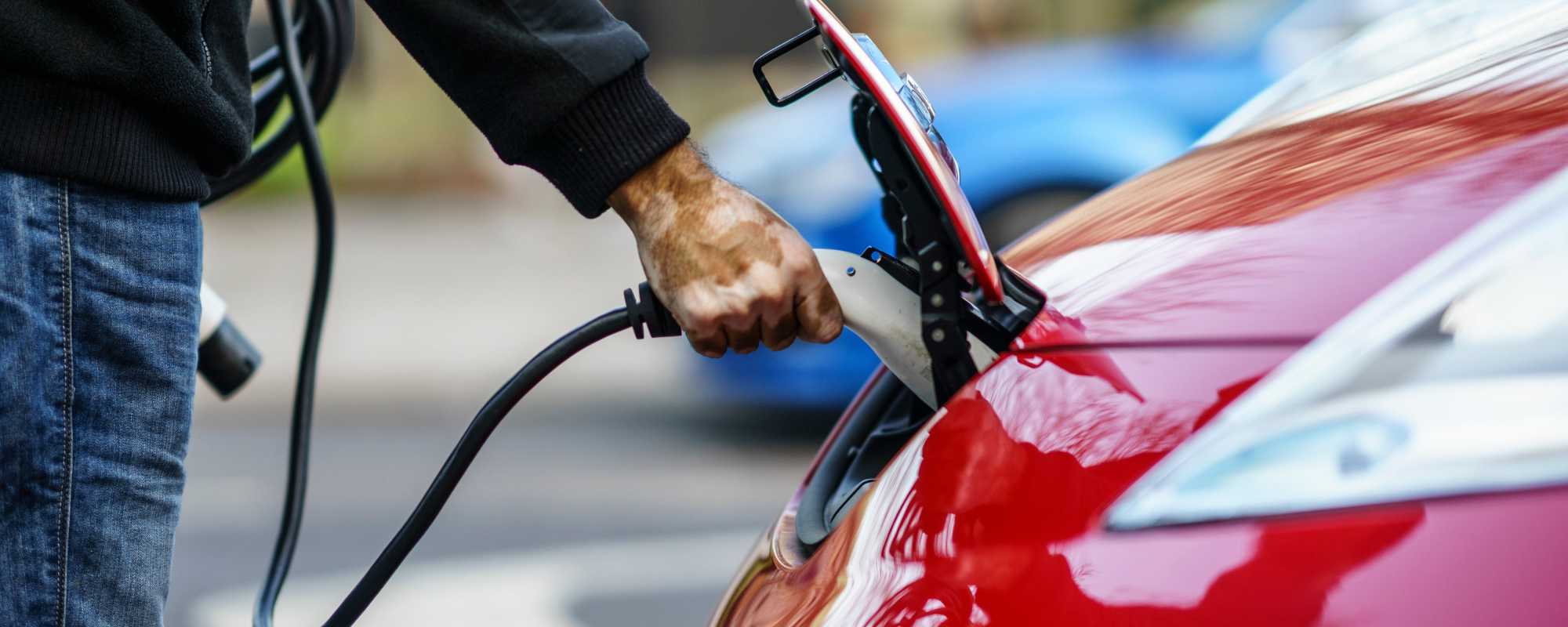 Man charging electric car