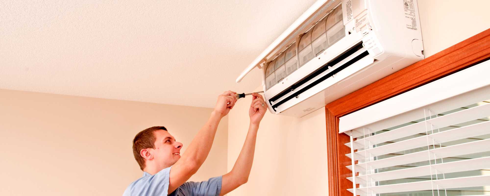 man installing a heat pump