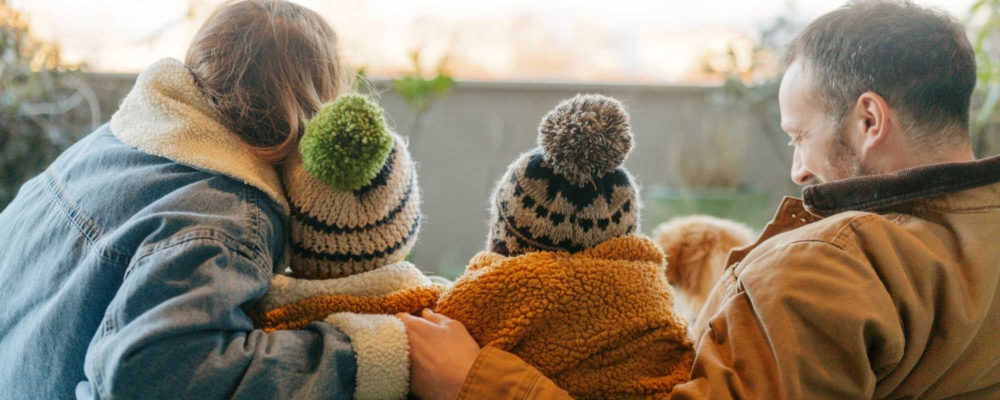 family bundled up during heating season